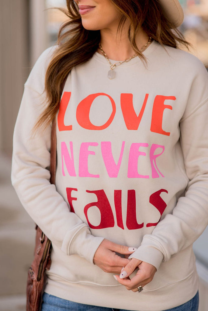 Love Never Fails Graphic Crewneck - Betsey's Boutique Shop -